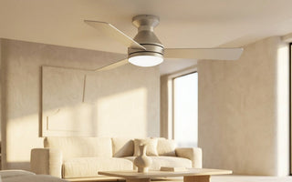 Modern ceiling fan with integrated LED light flush-mounted in a sunlit minimalist living room for contemporary home design