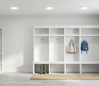 Bright American mudroom lit by slim canless LED recessed downlights — energy-efficient lighting for high-traffic entries