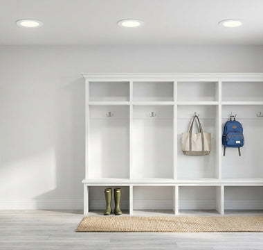 Bright American mudroom lit by slim canless LED recessed downlights — energy-efficient lighting for high-traffic entries