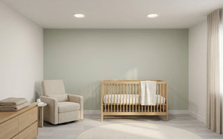 Calm American nursery lit by slim canless LED recessed downlights — safe, dimmable warm-white lighting for baby sleep