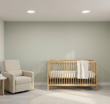 Calm American nursery lit by slim canless LED recessed downlights — safe, dimmable warm-white lighting for baby sleep